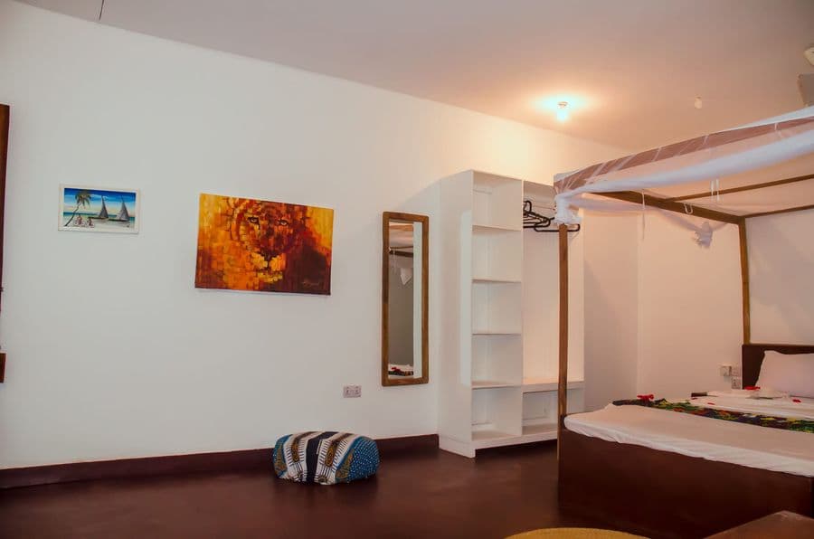 Spacious bedroom with a bed under a mosquito net